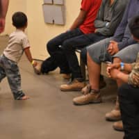 Migrant children, whose faces cannot be shown, are seen at the U.S. Customs and Border Protection Facility in Tucson, Arizona, during a visit by first lady Melania Trump last summer. President Donald Trump\'s administration announced Wednesday it would remove tough legal limits on how long migrant kids can be detained as part of its broader crackdown on undocumented immigrants. The Department of Homeland Security said it was ending the 1997 Flores Settlement Agreement. | AFP-JIJI