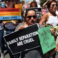 People demonstrate in Washington last summer demanding an end to the separation of migrant children from their parents. | AFP-JIJI