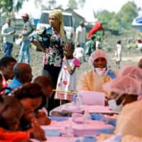 A woman and child wait to receive the Ebola vaccination in Goma, Democratic Republic of Congo, Aug. 5. | REUTERS