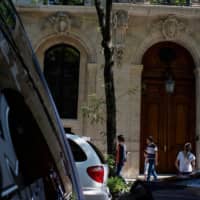 People pause in front of financier Jeffrey Epstein\'s house after he was found dead in his cell in the Manhattan Correctional Center of New York City Saturday. | REUTERS