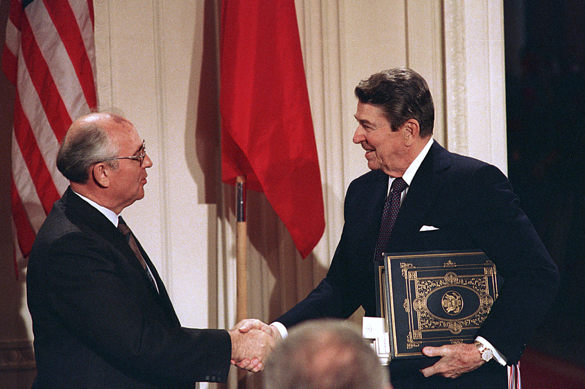 Soviet leader Mikhail Gorbachev and U.S. President Ronald Reagan shake hands after signing the Intermediate Range Nuclear Forces Treaty at the White House on Dec. 8, 1987. | AP