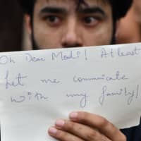 An activist takes part in a protest in Bangalore, India, on Monday in reaction to the government scrapping of Article 370, which granted special status to Jammu and Kashmir. | AFP-JIJI