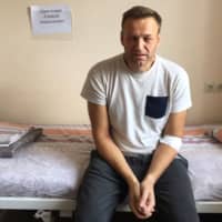 Russia\'s jailed opposition leader Alexei Navalny sitts on a hospital bed in Moscow Monday, when he said he might have been \"poisoned\" in his prison cell amid a crackdown on anti-Kremlin protesters. | HANDOUT / NAVALNY.COM / VIA AFP-JIJI
