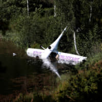 Norway\'s first battery-powered aircraft, piloted by Avinor Chief Executive Dag Falk-Petersen, is seen partly submerged in a lake after crash-landing, in Nornestjonn, Arendal, Norway, Wednesday. | NTB SCANPIX / HAKON MOSVOLD LARSEN / VIA REUTERS