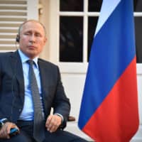 Russian President Vladimir Putin looks on during his meeting with his French counterpart at the French president\'s summer retreat at the Bregancon fortress on the Mediterranean coast, near the village of Bormes-les-Mimosas, southern France, on Monday. | AFP-JIJI