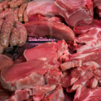 Sausages and cuts of pork and beef sit on a butcher\'s stall at a market in Berlin on Saturday. A national debate was triggered in the home of the Bratwurst when animal-rights activists urged lawmakers to raise the levy on meat products to 19 percent, from the current discounted rate of 7 percent, to fund improvements to the living conditions of livestock. | BLOOMBERG