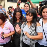 Salvadorean rape victim Evelyn Hernandez (second, right) leaves after a hearing in Delgado, San Salvador department, El Salvado, on Thursday. A court in El Salvador resume Thursday the trial of Hernandez over homicide charges after she gave birth to a stillborn baby at home. The country has an extremely strict abortion ban. | AFP-JIJI
