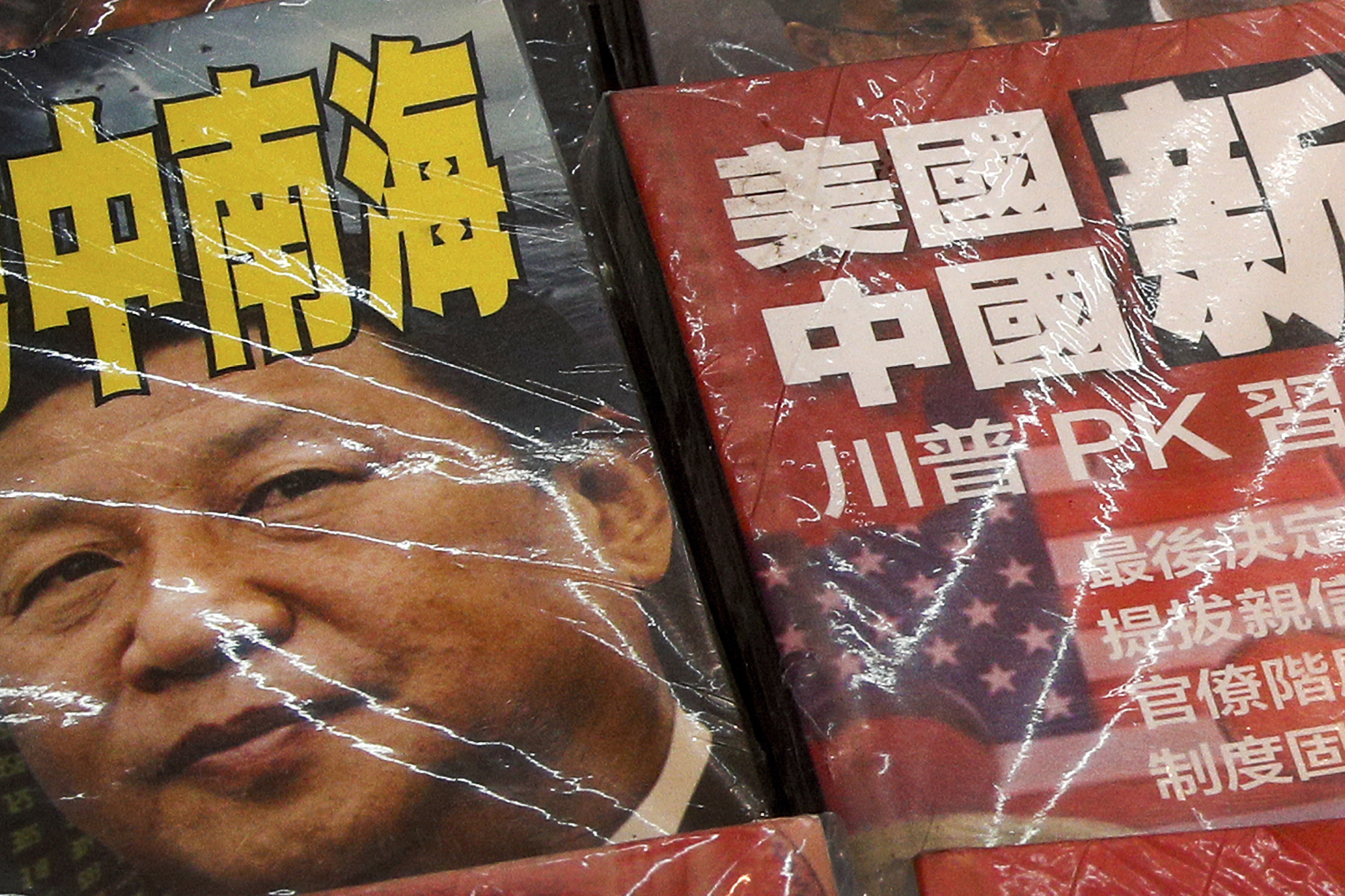 Magazines with front covers featuring Chinese President Xi Jinping and the words 'South China Sea' and 'Xi against U.S. President Donald Trump' are sold at a roadside bookstand in Hong Kong on July 4. | AP