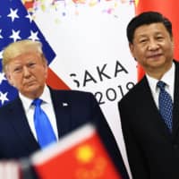 Chinese leader Xi Jinping and U.S. President Donald Trump attend a bilateral meeting on the sidelines of the Group of 20 Summit in Osaka on June 29. | AFP-JIJI
