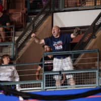 Frank Dawson, a supporter of U.S. President Donald Trump, cheers after helping evict protesters during a Trump campaign rally in Manchester, New Hampshire, on Thursday. Trump believed Dawson was one of the protesters and mocked his looks, saying \"That guy has a serious weight problem. Go home, start exercising! Get him out of here please.\" | AFP-JIJI