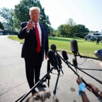 U.S. President Donald Trump speaks to the press as he departs the White House on Wednesday. | AFP-JIJI