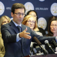 Washington Attorney General Bob Ferguson talks to reporters Monday during a news conference in Seattle. Nineteen states, including Washington, are suing over the Trump administration\'s effort to alter a federal agreement that limits how long immigrant children can be kept in detention. | AP