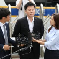 Yang Hyun-suk arrives at the Seoul Metropolitan Police Agency on Thursday. | YONHAP / VIA REUTERS