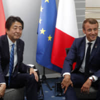 French President Emmanuel Macron attends a bilateral meeting with Prime Minister Shinzo Abe at the G7 summit in Biarritz, southwestern France, on Saturday. | AP