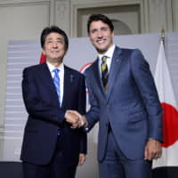 Canadian Prime Minister Justin Trudeau takes part in a bilateral meeting with Prime Minister Shinzo Abe during the G7 Summit in Biarritz, France, on Saturday. | AP