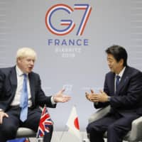 British Prime Minister Boris Johnson and Prime Minister Shinzo Abe hold talks in Biarritz, France, on Monday on the sidelines of the Group of Seven summit.  | KYODO
