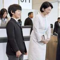 Prince Hisahito and Crown Princess Kiko are seen at Haneda airport Friday before leaving for Bhutan. | POOL / VIA KYODO
