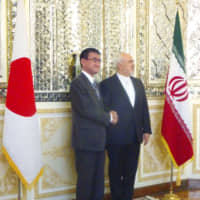 Foreign Minister Taro Kono and his Iranian counterpart Mohammad Javad Zarif shake hands during their meeting in Tehran on June 12. | KYODO