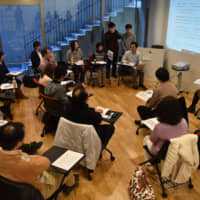 Former lay judges attend a gathering held at Senshu University in Tokyo in December to share their experiences. | KAHOKU SHIMPO