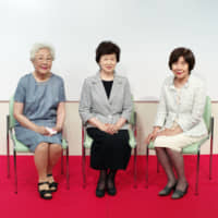 Former members of the translation team that volunteered during the 1964 Tokyo Paralympics (from left) Akiko Wakai, Mutsuko Inada and Akiko Gono speak about their experiences during the opening of an exhibit at the Japanese Red Cross Society in August. | RYUSEI TAKAHASHI