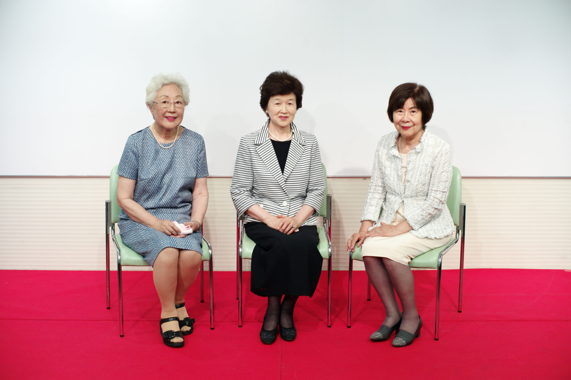 Former members of the translation team that volunteered during the 1964 Tokyo Paralympics (from left) Akiko Wakai, Mutsuko Inada and Akiko Gono speak about their experiences during the opening of an exhibit at the Japanese Red Cross Society in August. | RYUSEI TAKAHASHI