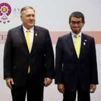Foreign Minister Taro Kono, U.S. Secretary of State Mike Pompeo and South Korean Foreign Minister Kang Kyung-wha pose after a trilateral meeting in Bangkok on Friday. | REUTERS