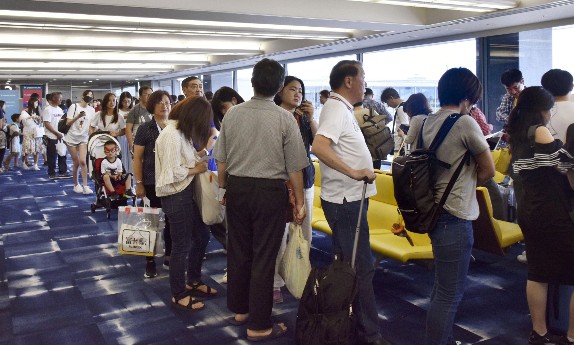Travelers prepare to board a flight to Hong Kong at Kansai International Airport on Tuesday. | KYODO