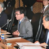 Foreign Minister Taro Kono (center) speaks while seated next to South Korean Foreign Minister Kang Kyung-wha (left) and Chinese Foreign Minister Wang Yi at a meeting in Manila in August 2017. | KYODO