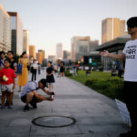 A Japanese man offers free hugs to South Koreans attending an anti-Japan rally in Seoul on Saturday. | REUTERS