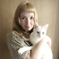 The purr-fect pair: Emmy van Gemert holds Momo, her new pet cat. | MASANARU ISHIZAKI