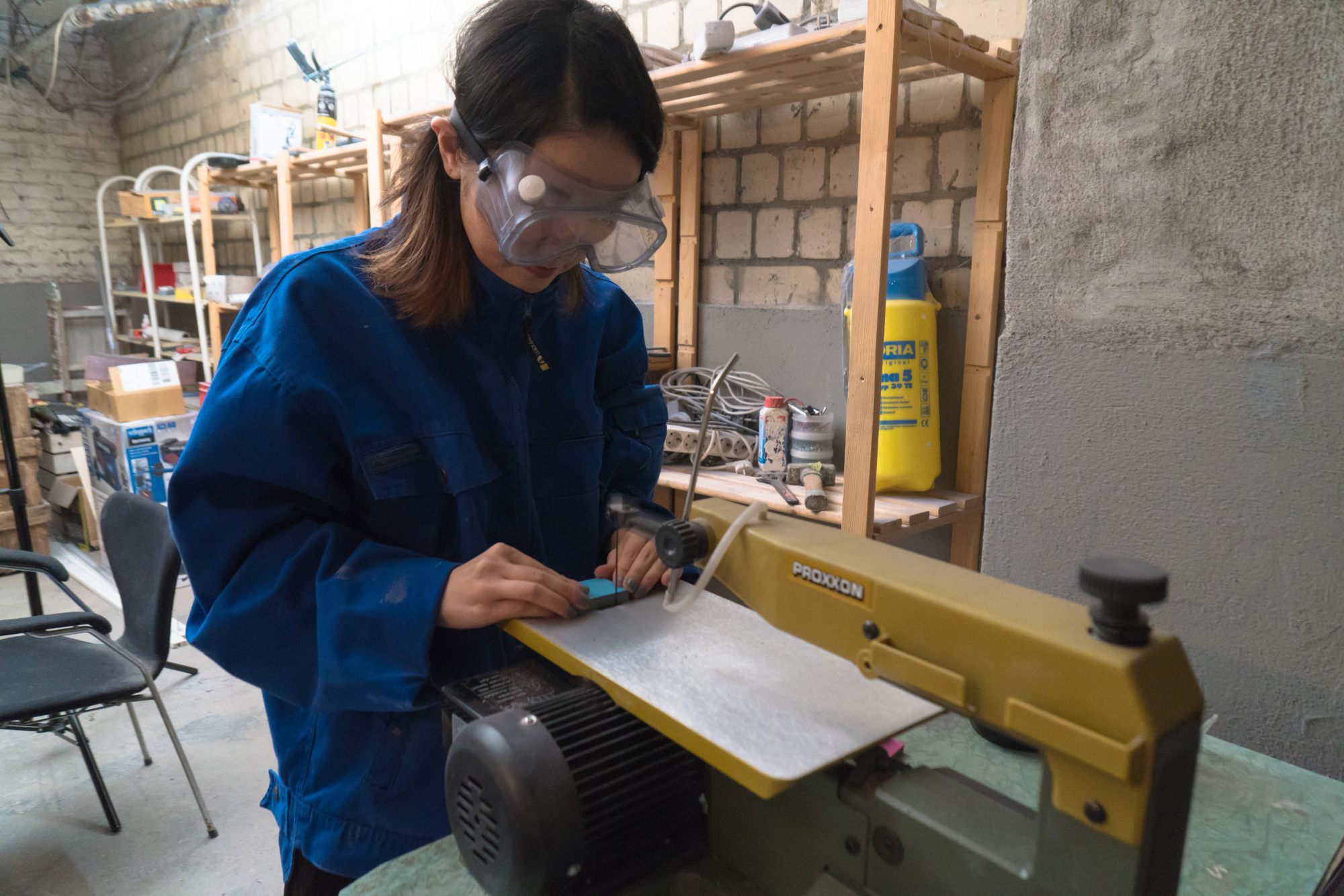 It's in the layers: Shiori Aiba cuts a block of layered colored paper, a textile that she designs and uses for her line of jewelry. | KARIN SHIKATA