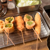This food’s got soul: A lineup of Rhythm and Kushikatsu Agatta’s skewers, including (from left) renkon (lotus), kabocha bejikushi  (mashed pumpkin filled with vegetables), tori (chicken), ingen bēkon-maki (string beans wrapped in bacon) and shishamo (smelt). | TSUYOSHI TAGAWA