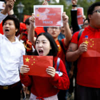 Supporters of the Chinese government hold a demonstration in London on Aug. 17 against the protests in Hong Kong. | REUTERS