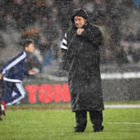 All Blacks coach Steve Hansen stands in the rain before a Bledisloe Cup test against the Wallabies on Saturday in Auckland. | AP