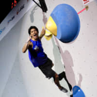 Tomoa Narasaki reacts after completing a bouldering route during the men\'s combined event at the IFSC World Championships at Esforta Arena Hachioji on Wednesday. | KAZ NAGATSUKA