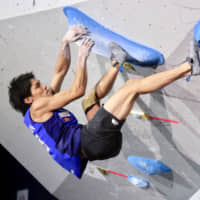Tomoa Narasaki works his way through a bouldering route during the men\'s combined event at the IFSC World Championships at Esforta Arena Hachioji on Wednesday. | KAZ NAGATSUKA