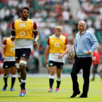 England head coach Eddie Jones watches his team practice on Sunday at Twickenham Stadium in London. | REUTERS