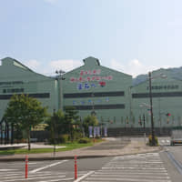 A banner on the wall of a Nippon Steel building in front of Kamaishi Station reads \"Welcome to Kamaishi, town of steel, seafood and rugby.\" | HIROSHI IKEZAWA