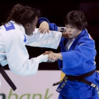 Shori Hamada (right) competes against France\'s Madeleine Malonga in the women\'s 78-kg division final at the World Judo Championships on Friday at Nippon Budokan. Hamada earned the silver medal. | KYODO