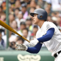 Riseisha\'s Kota Inoue watches his three-run home run in the third inning against Seiryo in the National High School Championship final at Koshien Stadium on Thursday. | KYODO