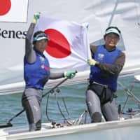 Ai Yoshida (left) and Miho Yoshioka celebrate after qualifying for the 2020 Tokyo Olympics on Friday in Fujisawa, Kanagawa Prefecture, where they placed second in the women\'s 470 class world championships. | KYODO