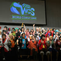 At the opening ceremony of the World Cosplay Summit 2019, Tokumaru Oguri (front row, fourth from left), executive committee chairman of the World Cosplay Summit 2019, and Mitsuko Shino (front row, fifth from left), director-general for cultural affairs and assistant minister for the Foreign Ministry, pose with cosplayers representing 39 countries and areas at the Tokyo Dome Hotel on July 26. The World Cosplay Championship will be held at the Aichi Arts Center on Aug. 4. | YOSHIAKI MIURA