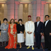 Komeito leader Natsuo Yamaguchi (far left) poses with (from second from left) Councilor Akiko Santo; Fatiha Bennani, spouse of the ambassador of Morocco; State Minister for Foreign Affairs Toshiko Abe; Moroccan Ambassador Rachad Bouhlal; Hirofumi Nakasone, president of the Japan-Morocco Parliamentary League; and Yuichiro Hata, secretary-general of the Japan Morocco Parliamentary League, at a reception celebrating the 20th anniversary of King Mohammed VI\'s enthronement at Hotel Okura Tokyo on July 30. | YOSHIAKI MIURA