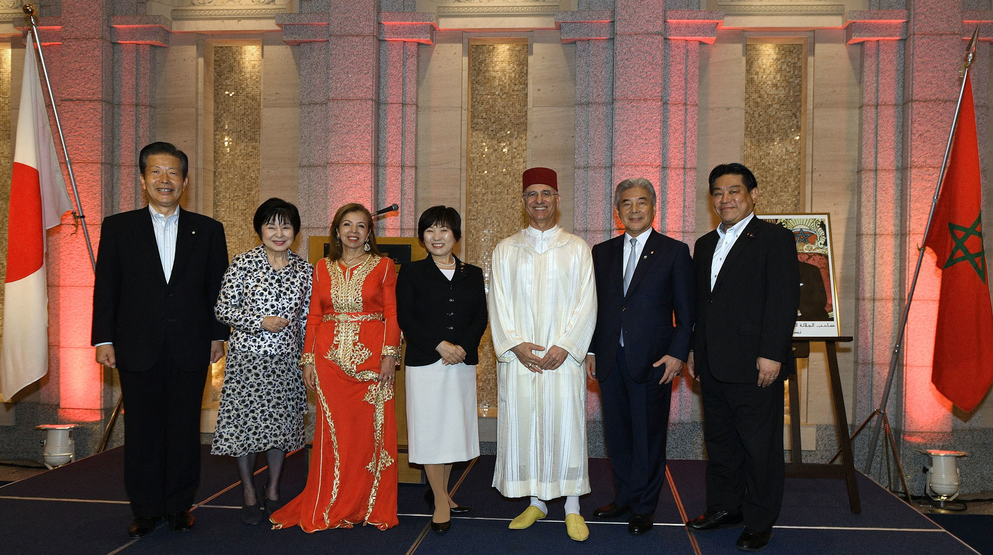 Komeito leader Natsuo Yamaguchi (far left) poses with (from second from left) Councilor Akiko Santo; Fatiha Bennani, spouse of the ambassador of Morocco; State Minister for Foreign Affairs Toshiko Abe; Moroccan Ambassador Rachad Bouhlal; Hirofumi Nakasone, president of the Japan-Morocco Parliamentary League; and Yuichiro Hata, secretary-general of the Japan Morocco Parliamentary League, at a reception celebrating the 20th anniversary of King Mohammed VI's enthronement at Hotel Okura Tokyo on July 30. |  YOSHIAKI MIURA