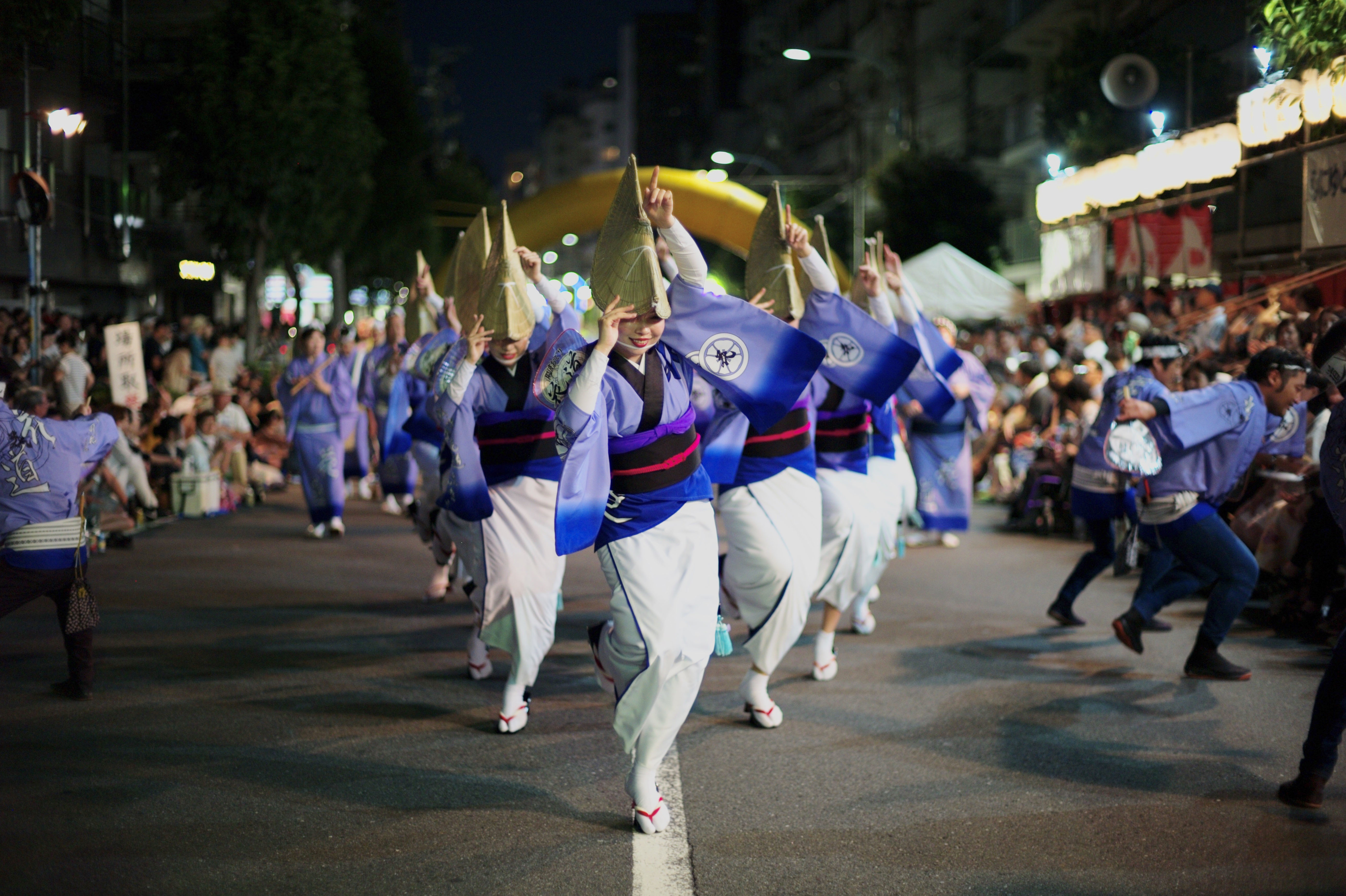 Female members of the Hanamichi-ren dance group perform during the first day of the 63rd annual Koenji Awa Odori on Saturday. More than 1 million people were expected to gather in Koenji, in Tokyo's Suginami Ward, during the two days of the festival. The annual event, which originated in Shikoku's Tokushima Prefecture, sees dance troupes parade through the streets to the accompaniment of drums, flutes and shamisen. | RYUSEI TAKAHASHI