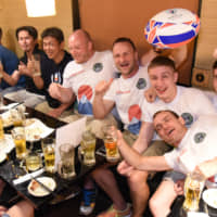 Supporters of Russia\'s men\'s rugby team, including members of the Moscow State University Rugby Club, drink at a pub in Tokyo\'s Shinjuku on Thursday night. | DAN ORLOWITZ