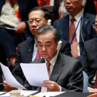 Chinese Foreign Minister Wang Yi attends a United Nations Security Council meeting on the sidelines of the 74th session of the United Nations General Assembly at U.N., headquarters in New York Wednesday. | REUTERS