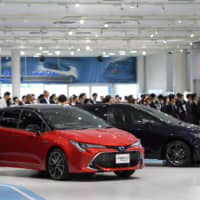 A Corolla Sport vehicle (left) and a Corolla Touring vehicle, both manufactured by Toyota Motor Corp., sit on display during an unveiling event in Tokyo on Tuesday. | BLOOMBERG