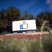 The Facebook sign and logo are seen in Menlo Park, California, in 2016. Facebook said technology firms and U.S. officials met at its Silicon Valley headquarters Wednesday to collaborate on protecting next year\'s presidential election from cyberthreats. | AFP-JIJI