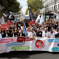 Protesters demonstrate against the pension reforms in Paris on Monday. | AFP-JIJI